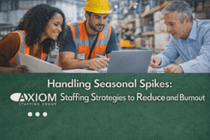 Warehouse managers reviewing staffing plans on a laptop during peak season, with headline text about reducing overtime and burnout through strategic staffing.