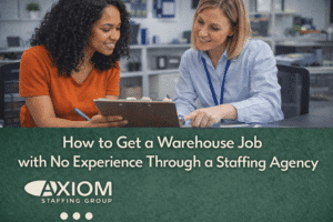 Staffing recruiter reviewing paperwork with a job candidate in an office setting, with headline text about getting a warehouse job with no experience through a staffing agency.