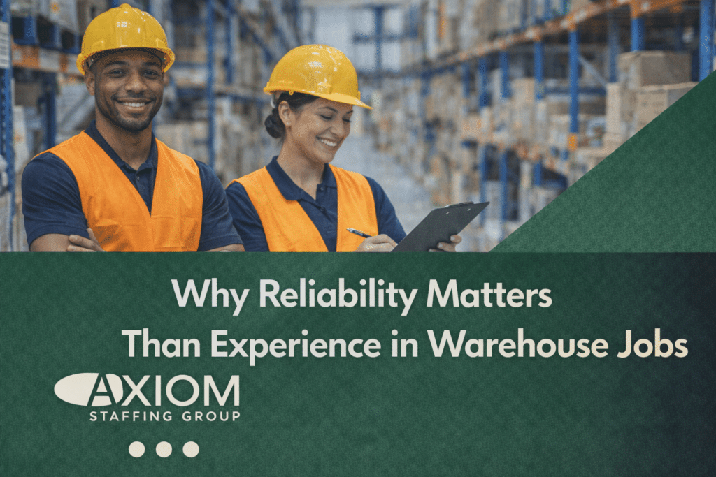 Two warehouse workers wearing safety vests and hard hats standing in a distribution center, featured in a banner discussing why reliability is more important than experience in warehouse jobs, by Axiom Staffing Group.