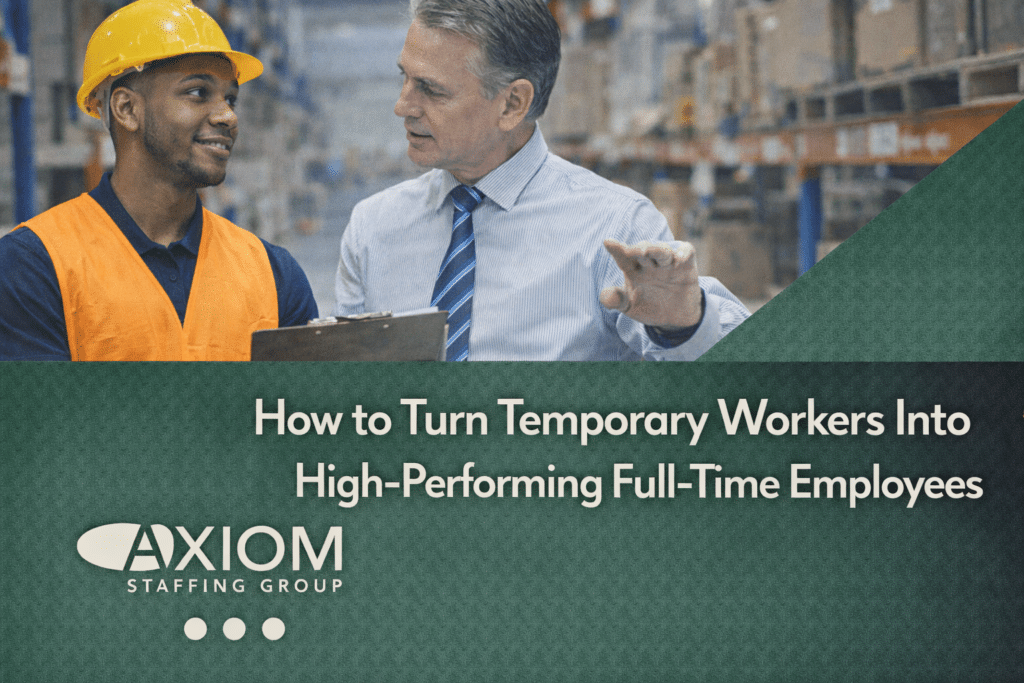 Warehouse supervisor mentoring a temporary worker wearing a safety vest and hard hat in a distribution center, featured in a banner about converting temporary workers into high-performing full-time employees, by Axiom Staffing Group.